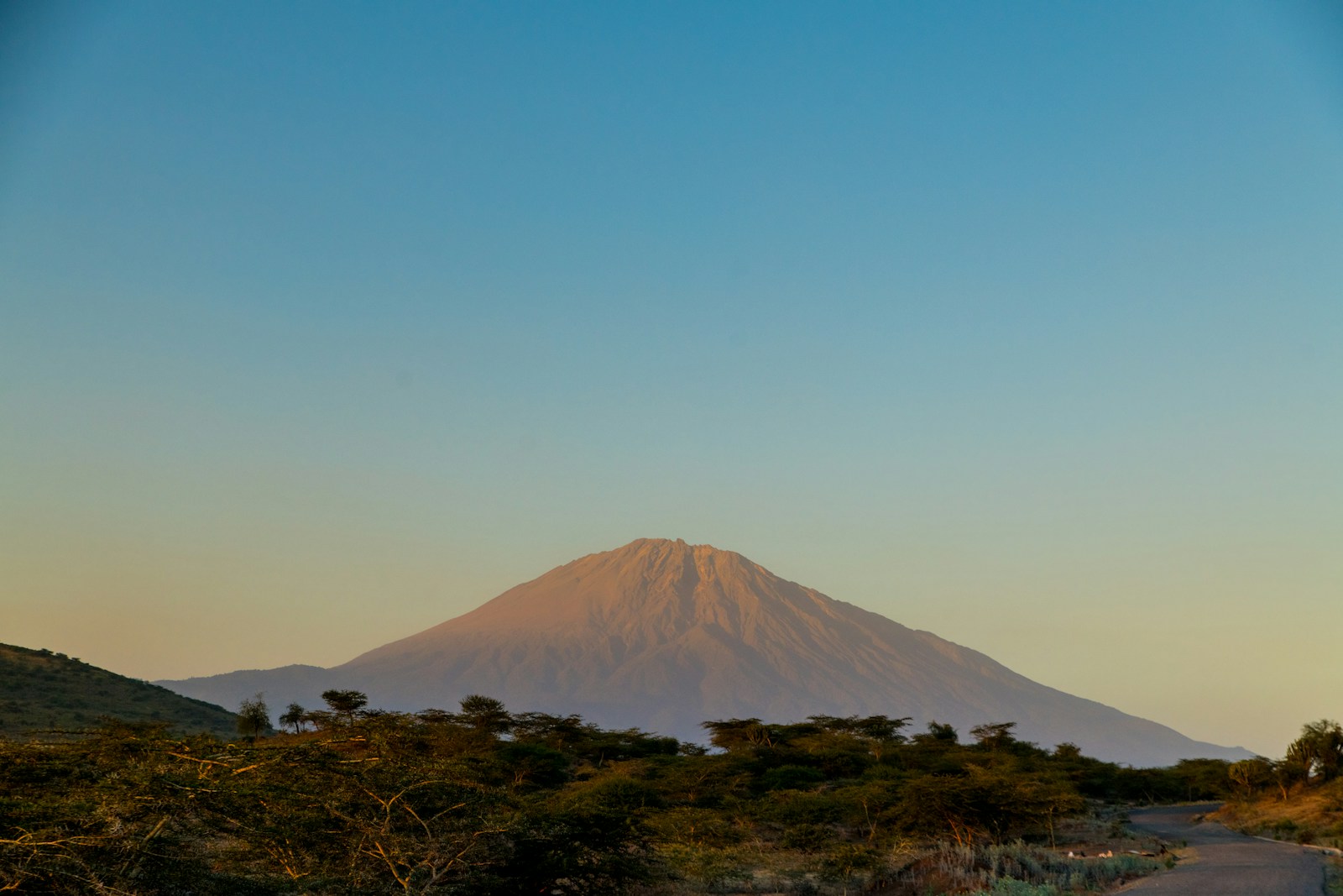 Arusha National Park 3 brown mountain under blue sky during daytime
